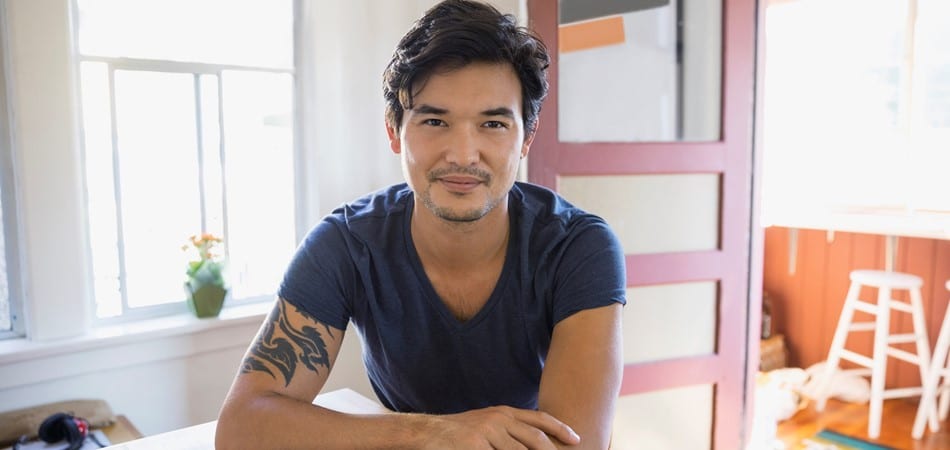 Man leaning forward and smiling into camera
