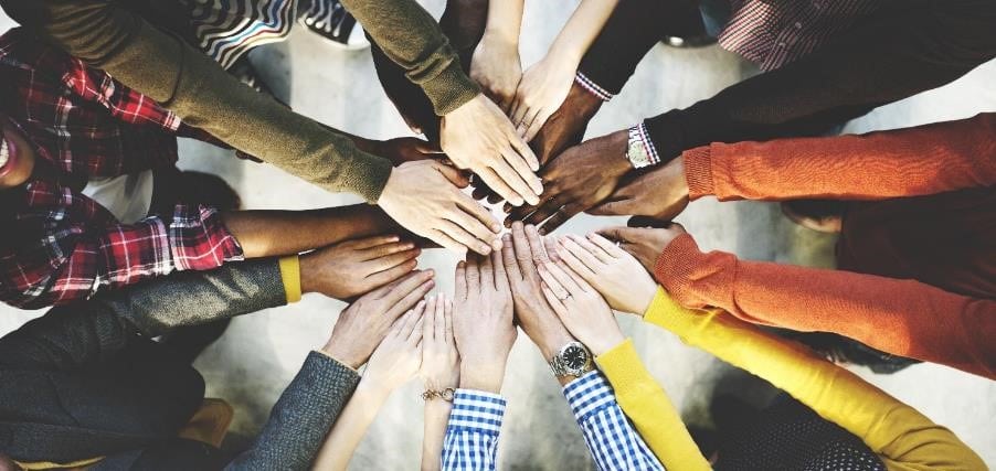 Group of hands joining in a circle