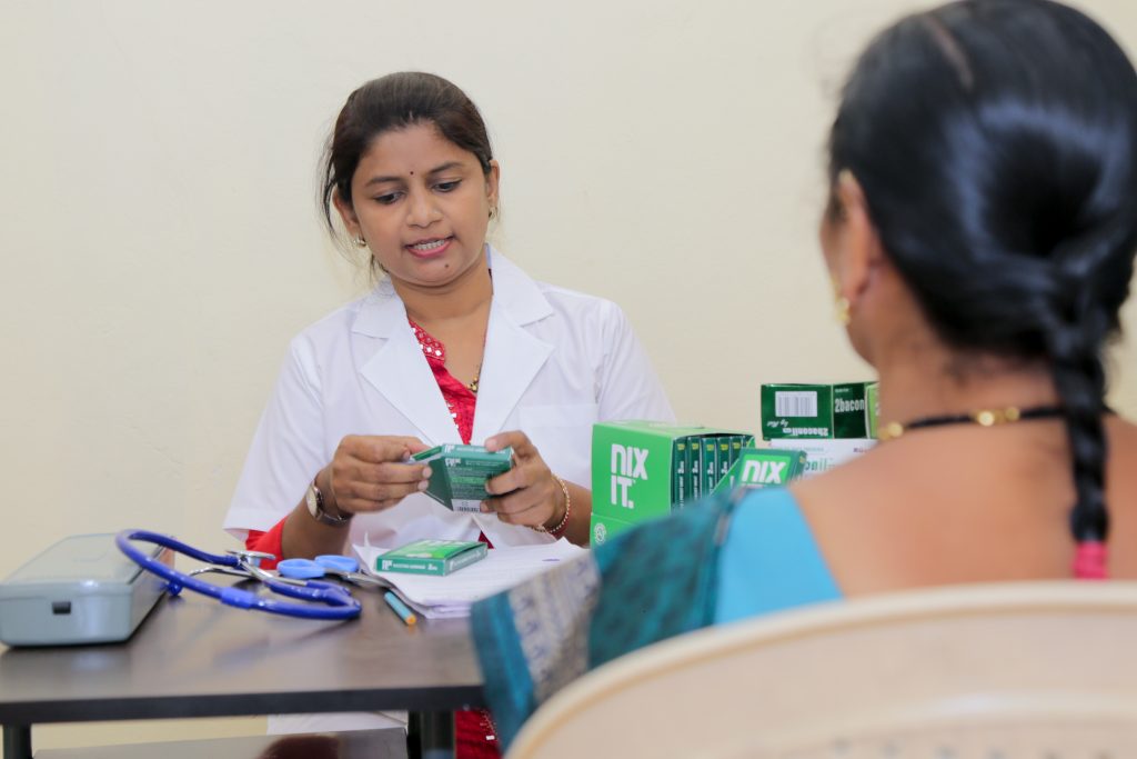 Doctor sitting across a table with patient, exploring nicotine lozenges