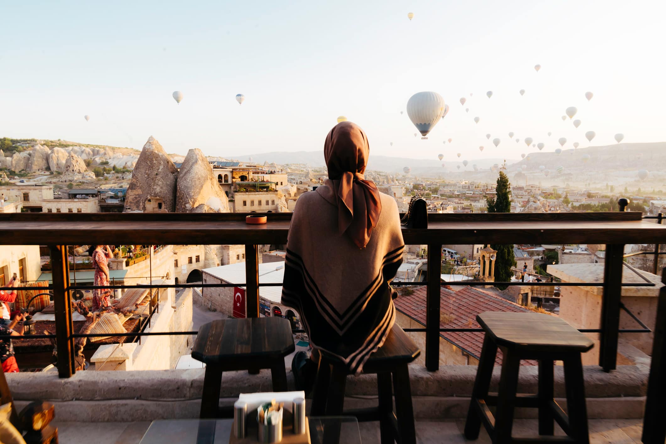 Person looking over at hot air balloons in Turkey