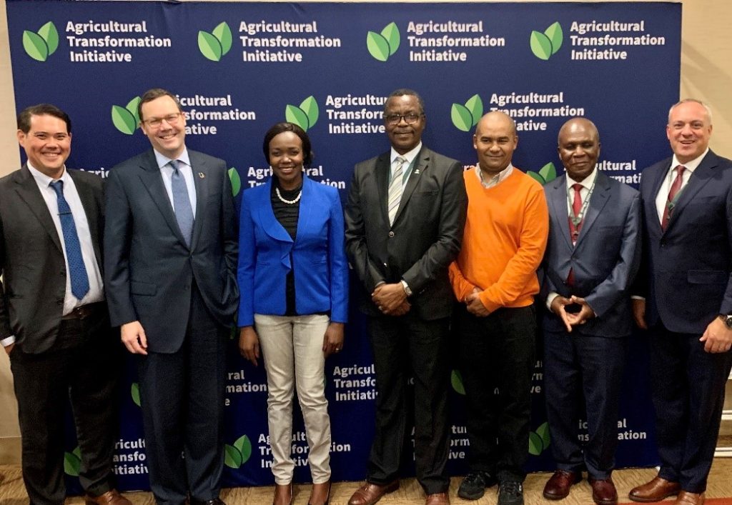 Group image of people standing in front of a backdrop